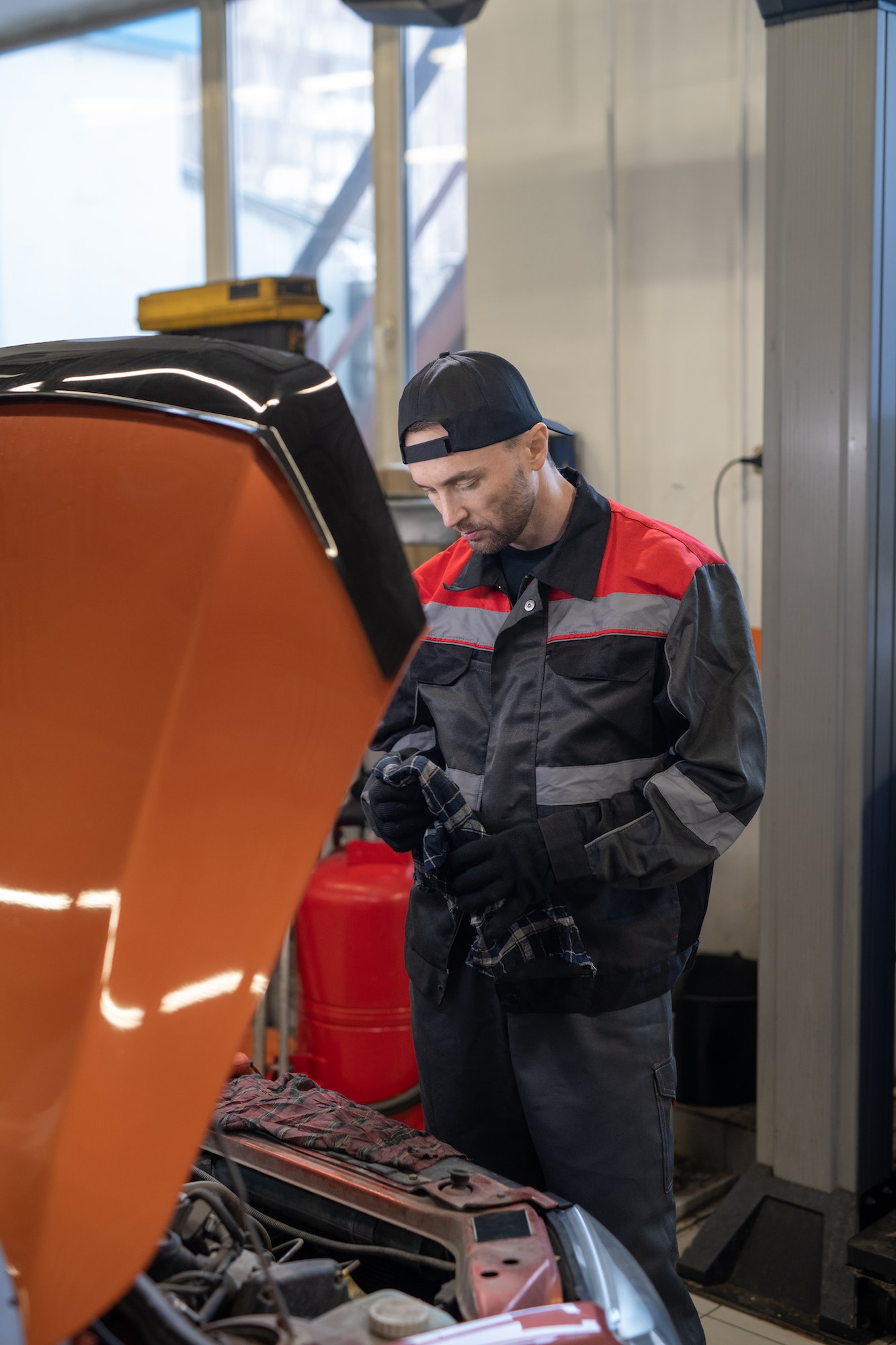 Experienced mobile mechanic repairing car engine with hood open in Laurel MD